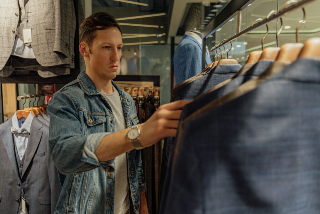Man selecting a perfect jacket for elevating the look. Man selecting a perfect jacket for elevating the look.