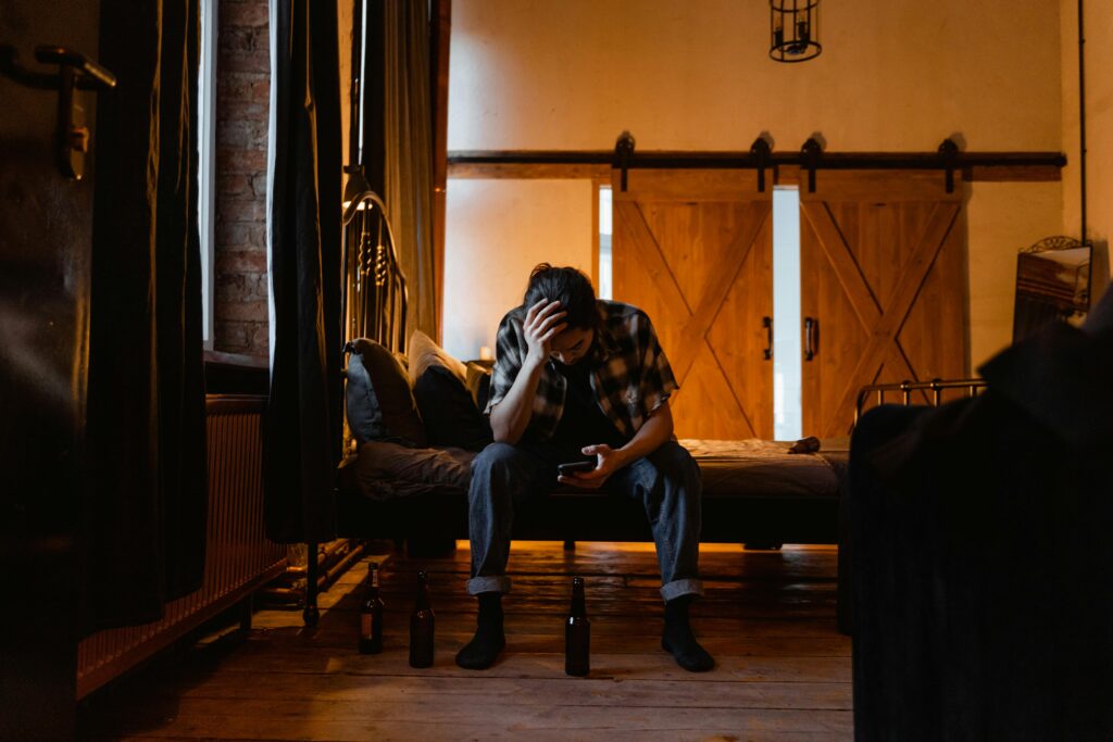 The Power Of Saying No A person sitting on a bed looking overwhelmed—symbolizing saying yes too often.