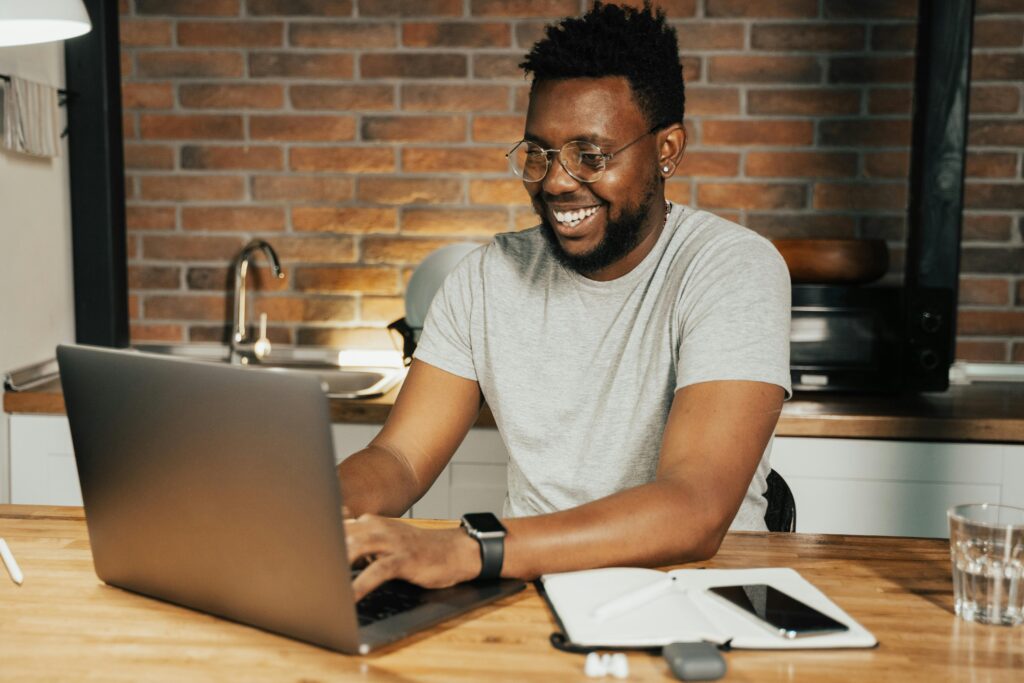 The Power Of Saying No A person gently closing a laptop with a smile-representing ending work on time