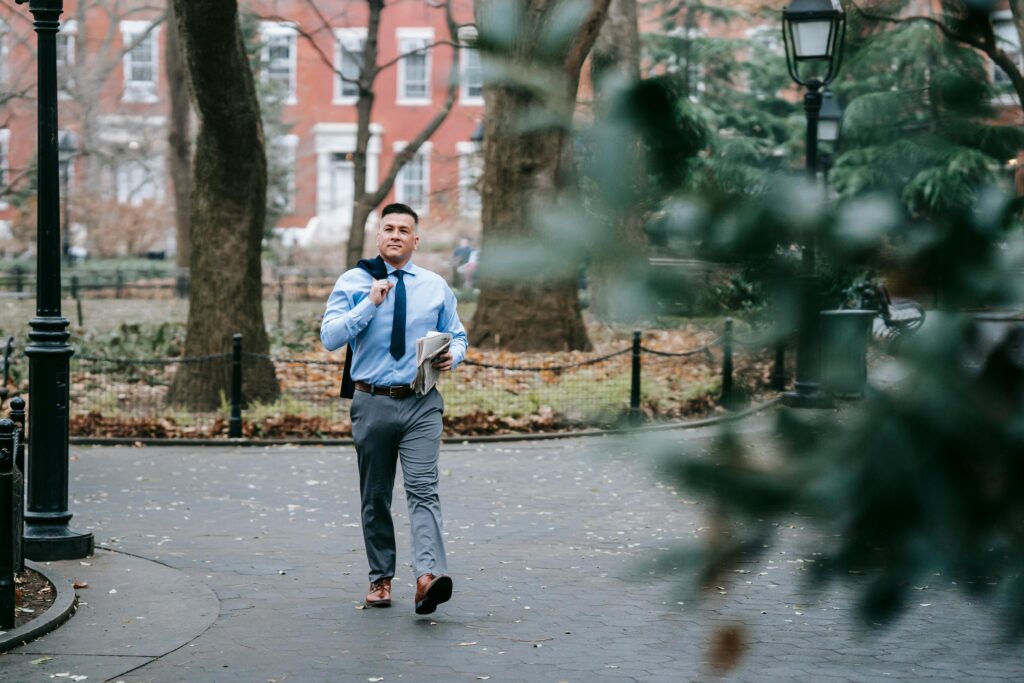 The Power Of Saying No A person walking confidently down a path that splits from a busy road.