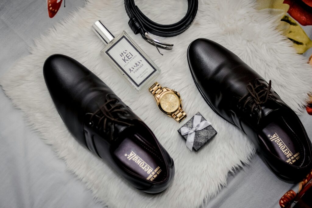 Flat lay of modern man accessories Modern men’s accessories flat lay including watch, sunglasses, leather wallet and fragrance bottle.