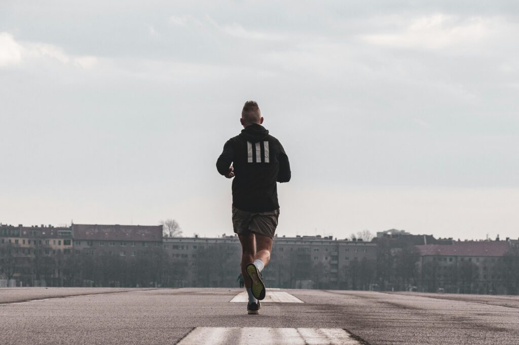 Man running outdoors to clear his mind and break the overthinking cycle through exercise