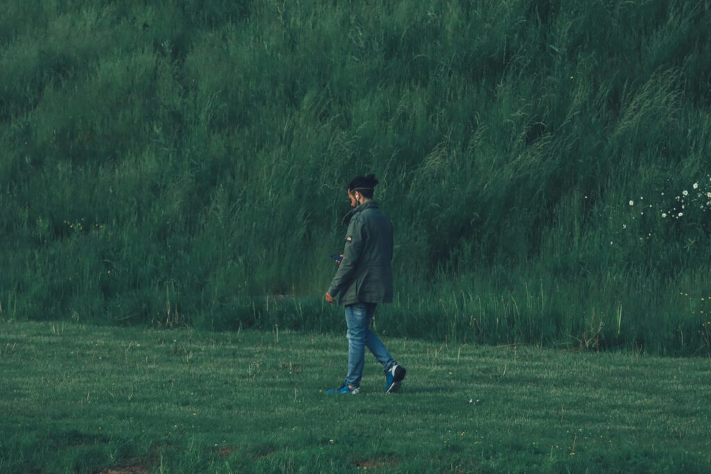 Person walking gently in a park as a burnout recovery technique to reduce cortisol and restore energy