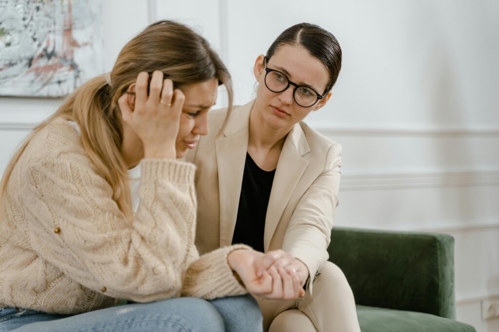 Two people in a supportive conversation representing the importance of seeking professional help during burnout recovery