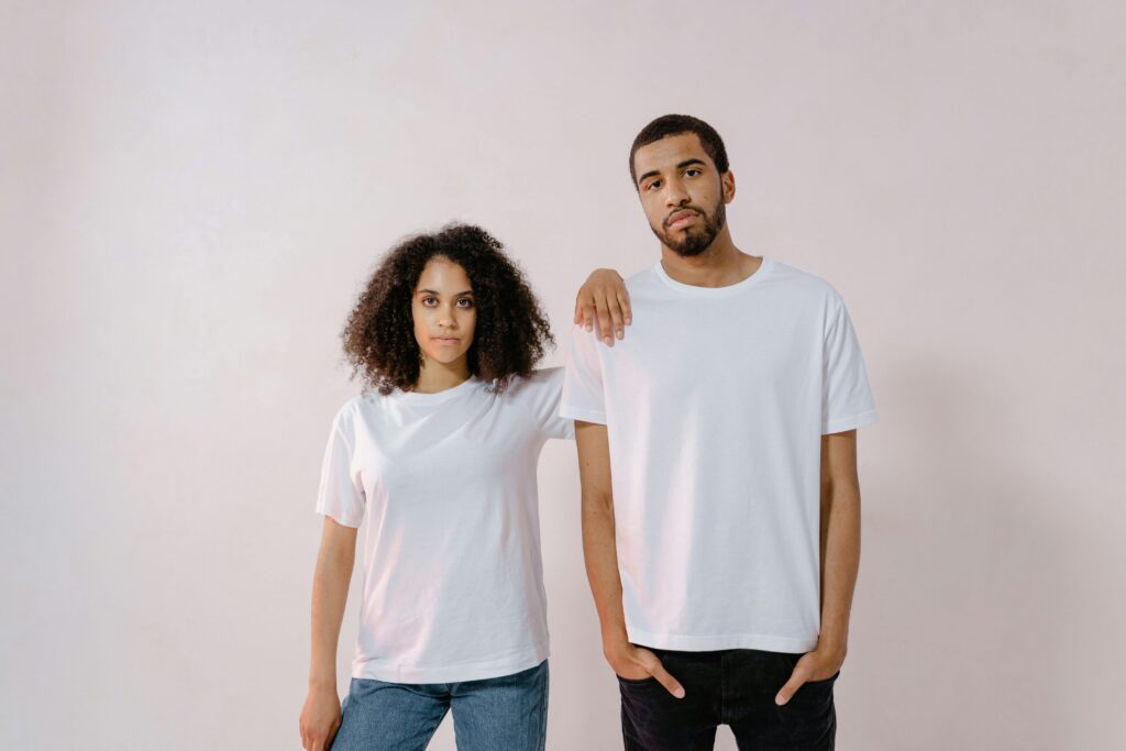 Minimal men’s outfit with a basic t-shirt, jeans, and clean sneakers for budget-friendly style.