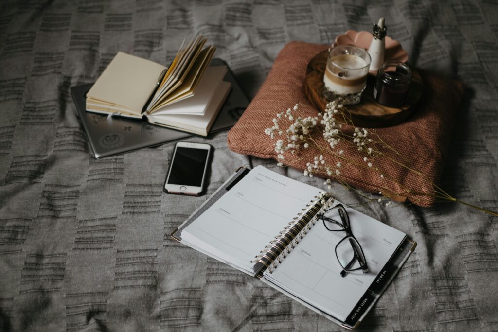 Evening gratitude journaling setup with warm bedside light.